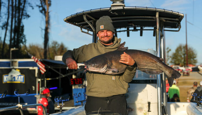 Man with a large catfish at fishing tournament